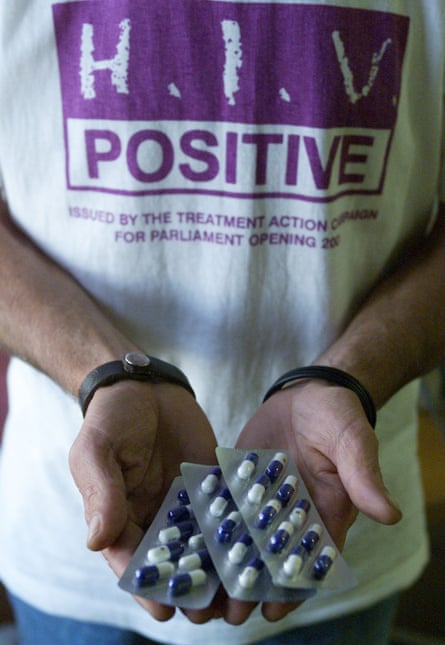 A South African Aids activist holds capsules of a generic medicine.
