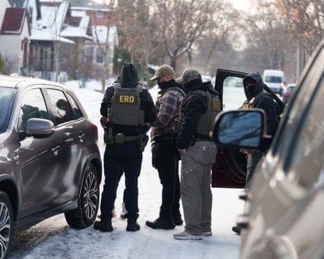 Federal immigration agents surround a Somali American citizen and ask for his documentation after seeing him making a delivery on a residential street in Minneapolis, 7 January 2026.