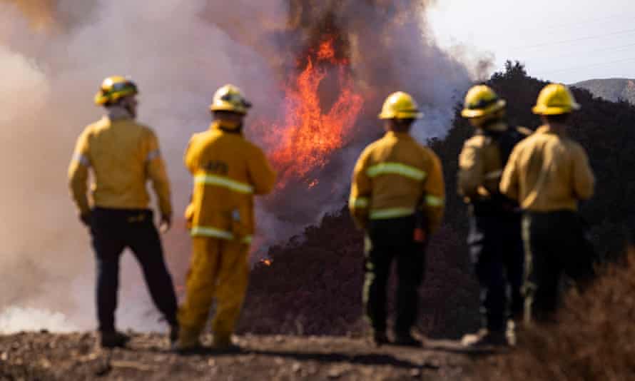 Firefighters watch as the Getty fire spreads in the hills behind the Getty Center in Los Angeles, California, 28 October 2019.