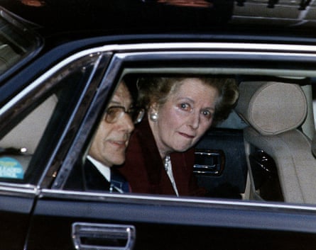 Margaret Thatcher looks out of window of a black car as she is driven away; there are tears in her eyes.