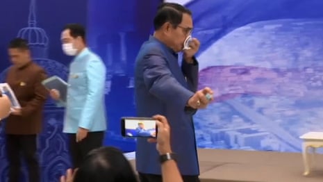 Thai PM sprays disinfectant on journalists at press conference – video