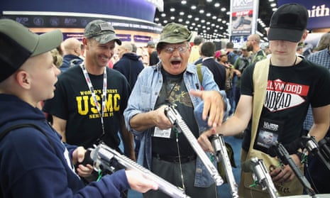 Gun enthusiasts look over Smith &amp; Wesson pistols at the annual NRA event on Saturday in Louisville, Kentucky. 