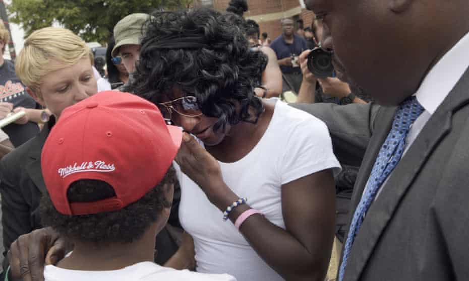 Gloria Darden wipes away tears after prosecutors dropped remaining charges against the three Baltimore police officers who were awaiting trial over her son Freddie Gray’s death.