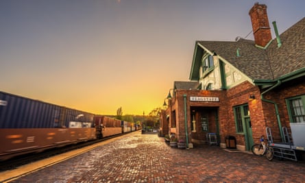 Amtrak Train going through the historic train station in Flagstaff at sunset.