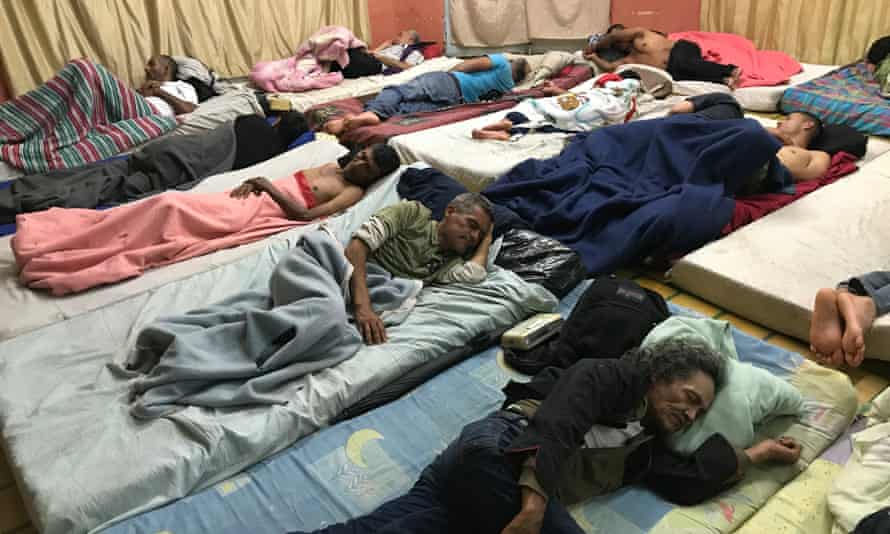 Migrants sleep inside a church in San José’s red light district.