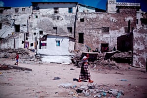 A man walks passed some old houses near the port in in the Somali capital Mogadishu