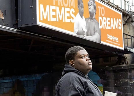 Dieunerst Collin standing in front of Popeyes billboard with a picture of him as a kid on it