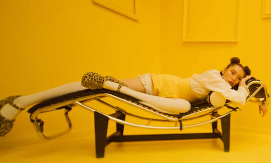 singer jaguar jonze lies on a backless lounge
