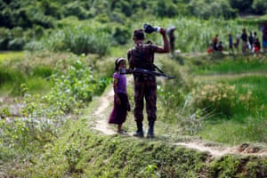 A member of Border Guard Bangladesh stops a Rohingya girl from crossing on to the Bangladesh side, in Cox’s Bazar, Bangladesh.