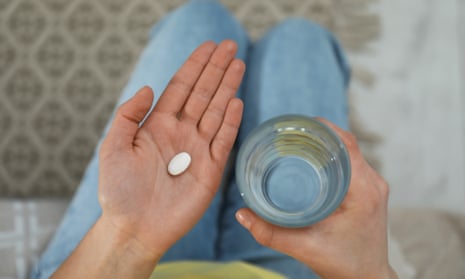 A young woman with an abortion pill and a glass of water. An increasing number of organizations are offering abortion in international waters after Roe v Wade.