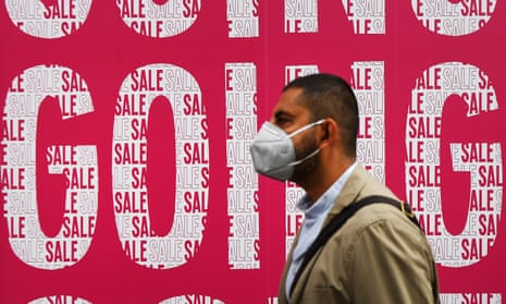 A pedestrian passes a sale sign outside a store in central London, 10 July 2020.