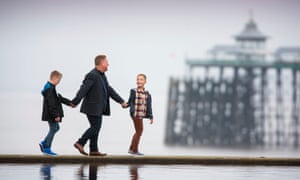 Singe with his sons at Clevedon beach, Somerset.