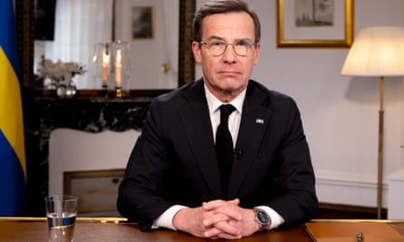 The Swedish prime minister, Ulf Kristersson, sitting at a desk in his office