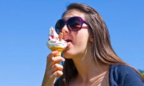 Girl with large sunglasses eating a 99 ice cream
