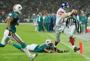 New York quarterback, Eli Manning outpaces Jason Taylor of the Dolphins to score the Giants only touchdown of the game.
