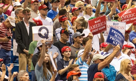 A Trump supporter holds up a QAnon sign in Tampa.