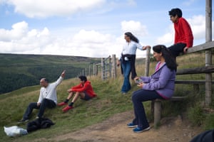 A family pauses for a quick break as they hike through the hills surrounding Dovestone reservoir.