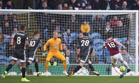 Burnley’s midfielder Ashley Westwood (R) shoots past Leicester City’s goalkeeper Kasper Schmeichel.