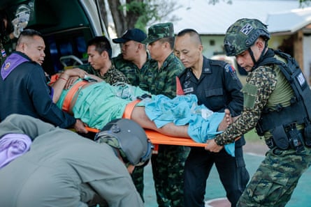 An injured Thai soldier is taken away for treatment after clashes along the border.
