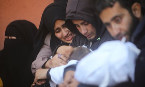 Palestinians mourn for relatives killed in the Israeli bombardment of the Gaza Strip outside a morgue in Khan Younis on Sunday.