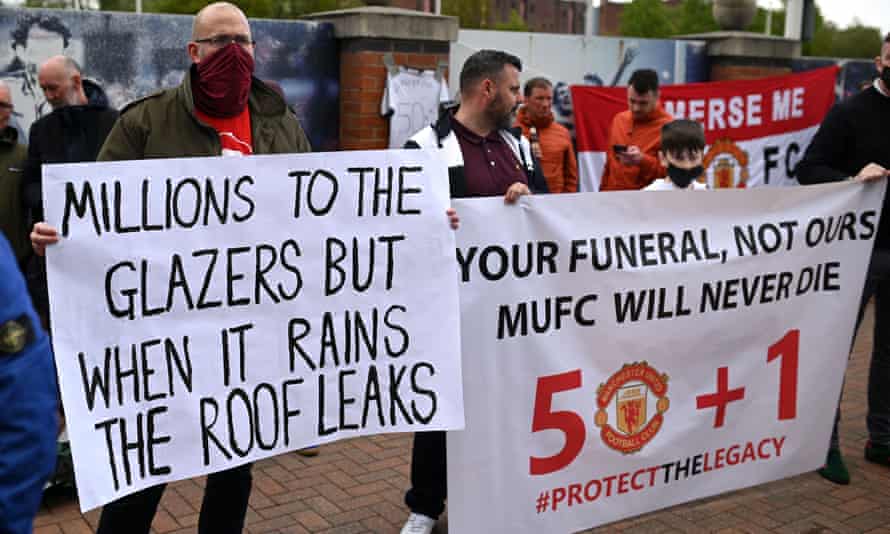 Les partisans brandissent des banderoles alors qu'ils protestent contre les propriétaires de Manchester United