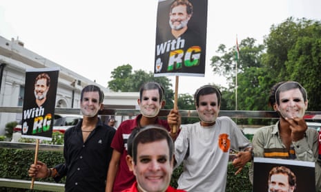 Congress party supporters wearing Rahul Gandhi masks protesting outside the party's headquarters in New Delhi last month