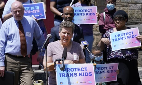 protesters with signs reading protect trans kids