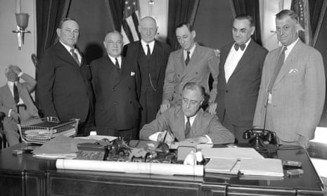 President Franklin D Roosevelt signs the Industrial Control-Public Works Act at the White House in 1933. Whether to embrace or reject the legacy of the New Deal has troubled the Democratic party for decades.