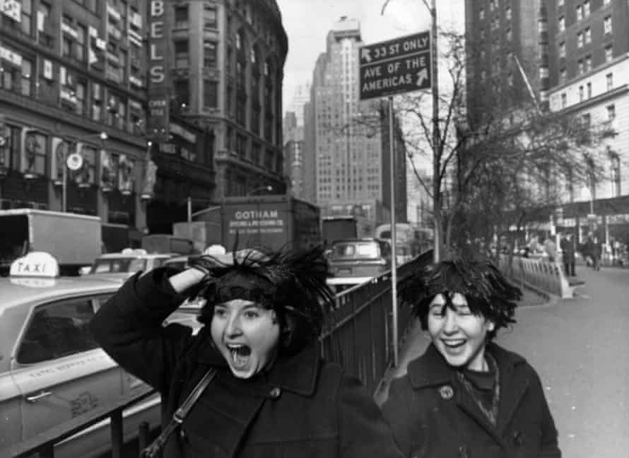Two American fans trying out their Beatles wigs ahead of the group’s arrival in New York, 6 February 1964.