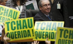 Lower house speaker Eduardo Cunha, the leader of the impeachment drive, observes anti-Rousseff congressmen with placards stating ‘Bye Honey.’