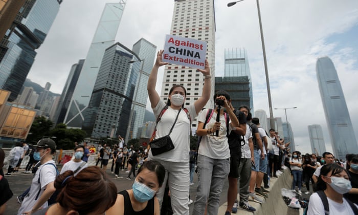 A protester holds up a placard reading “Against China extradition” during a demonstration against a proposed extradition bill in Hong Kong.