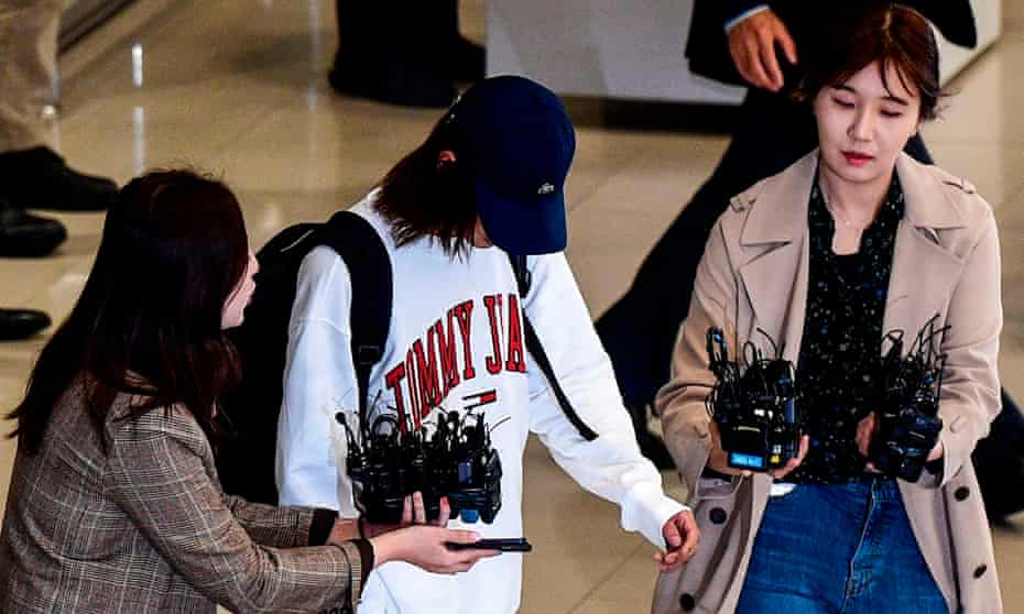 K-pop star Jung Joon-young surrounded by reporters as he arrives at Incheon international airport amid the K-pop sex scandal 