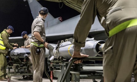 Technicians load weapons to the RAF aircraft ahead of the strikes on Saturday.