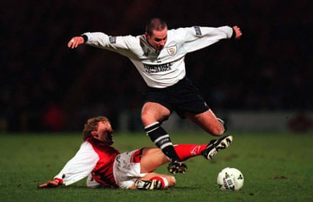 Allen Tankard dribbles past Ray Parlour during the replay at Vale Park.