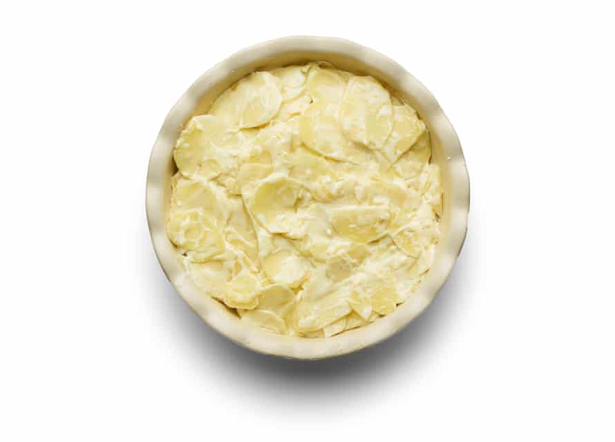 How to make gratin dauphinois – recipe | Food 7 Felicity Cloake’s masterclass – dauphinois potatoes_06 Put potato in dish.