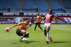 Villa’s Keinan Davis blocks a clearance from Conor Coady.