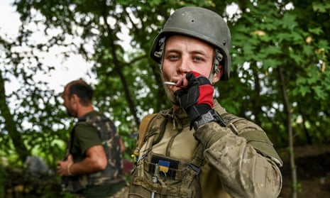 A Ukrainian serviceman smokes at a position near a frontline in Zaporizhzhia region, Ukraine, on 17 July.