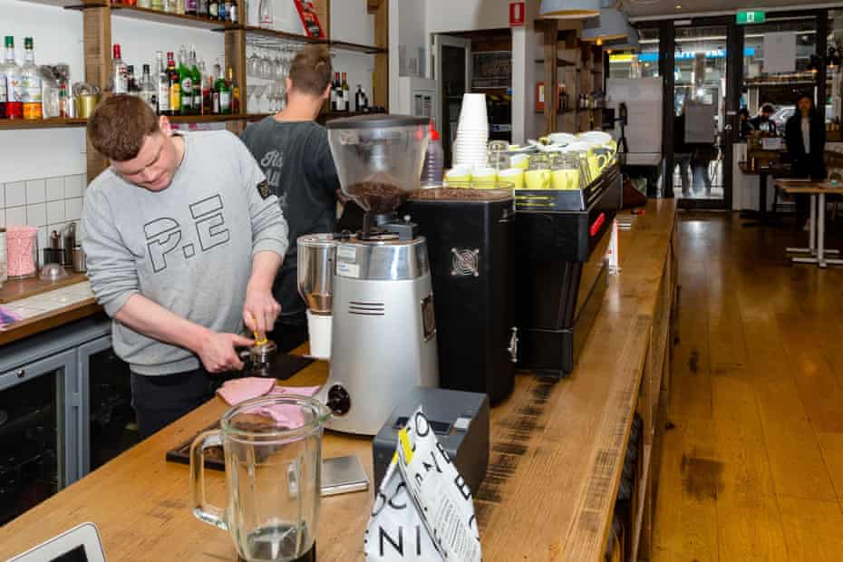 Baristas make takeaway coffees at the Lucky Penny Café in South Yarra, Melbourne.