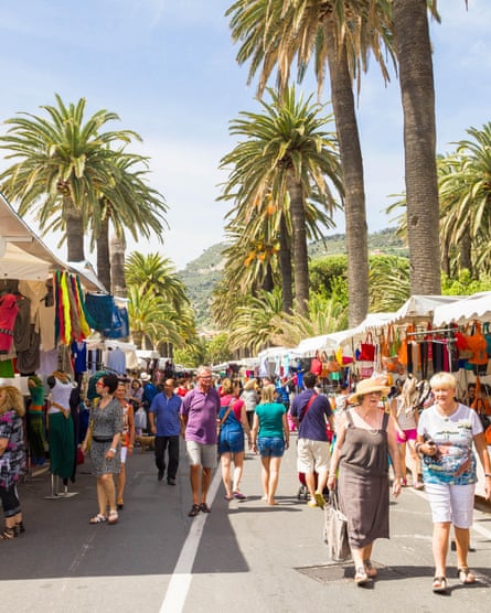 French tourists shop in the street market in Ventimiglia.