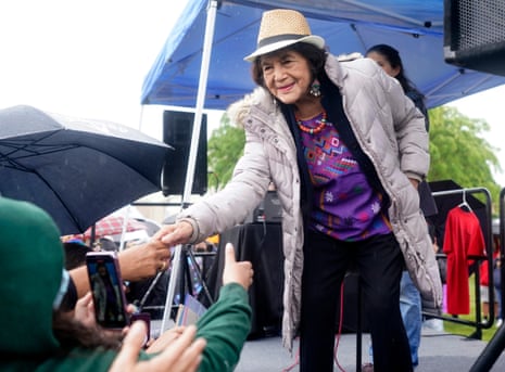 Dolores Huerta leaning forward to shake somebody’s hand