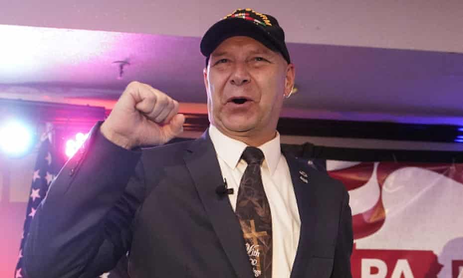 Doug Mastriano pumps a fist at his primary election party.