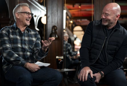 Gary Lineker speaks to a smiling Alan Shearer as they record a podcast in a pub