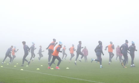 Young Manchester City players train in extreme fog at the club’s academy on Monday.