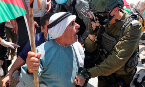 ‘There is a serious argument about injustices to be had’. An Israeli border guard gestures at a Palestinian protester in July 2020.