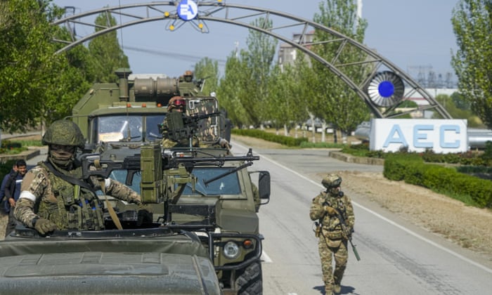 Russian forces driving through the gates of the Zaporizhzhia nuclear power station in Energodar, Ukraine, in May