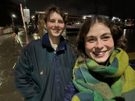 Two young people at night smiling in a selfie