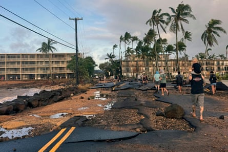 people walk along a damaged road people walk along a damaged road