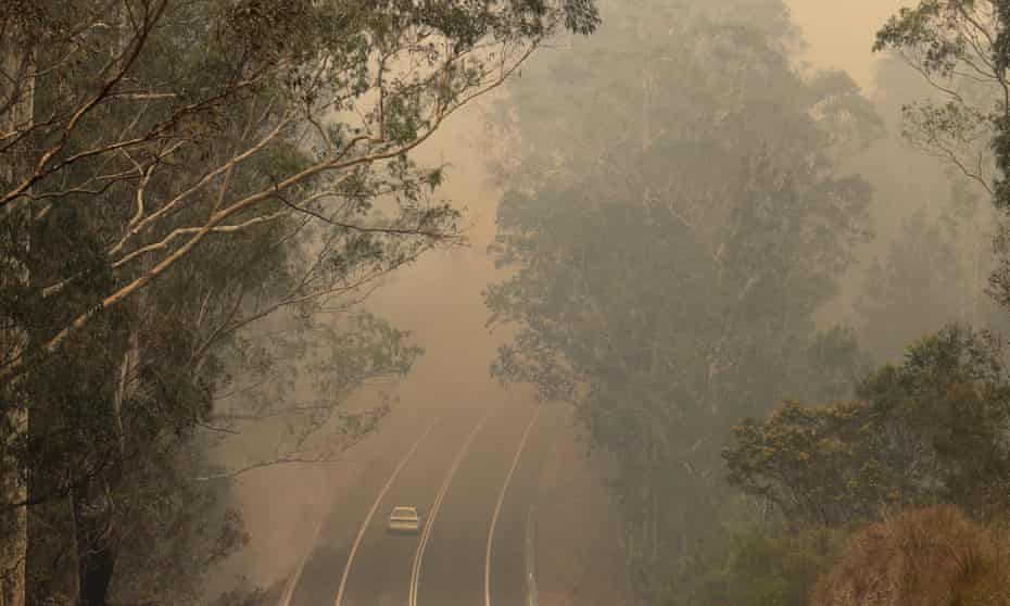 Smoke from wildfires shrouds a road near Moruya