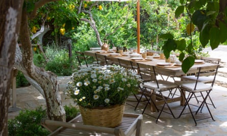 Outdoor breakfast area under the lemon trees at Ktima Lemonies guesthouse, Andros, Greece.