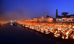 People light earthen lamps on the banks of the river Sarayu during Deepotsav celebrations on the eve of the Hindu festival of Diwali in Ayodhya on 3 November, 2021.